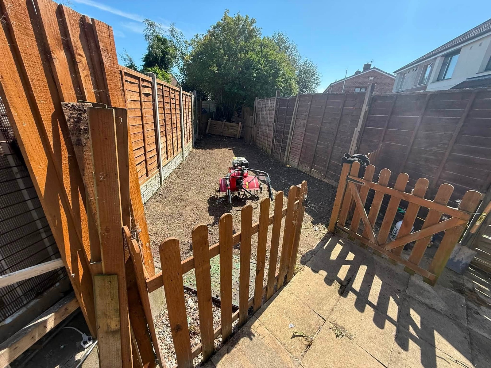 Garden boundary with timber fencing during landscaping work