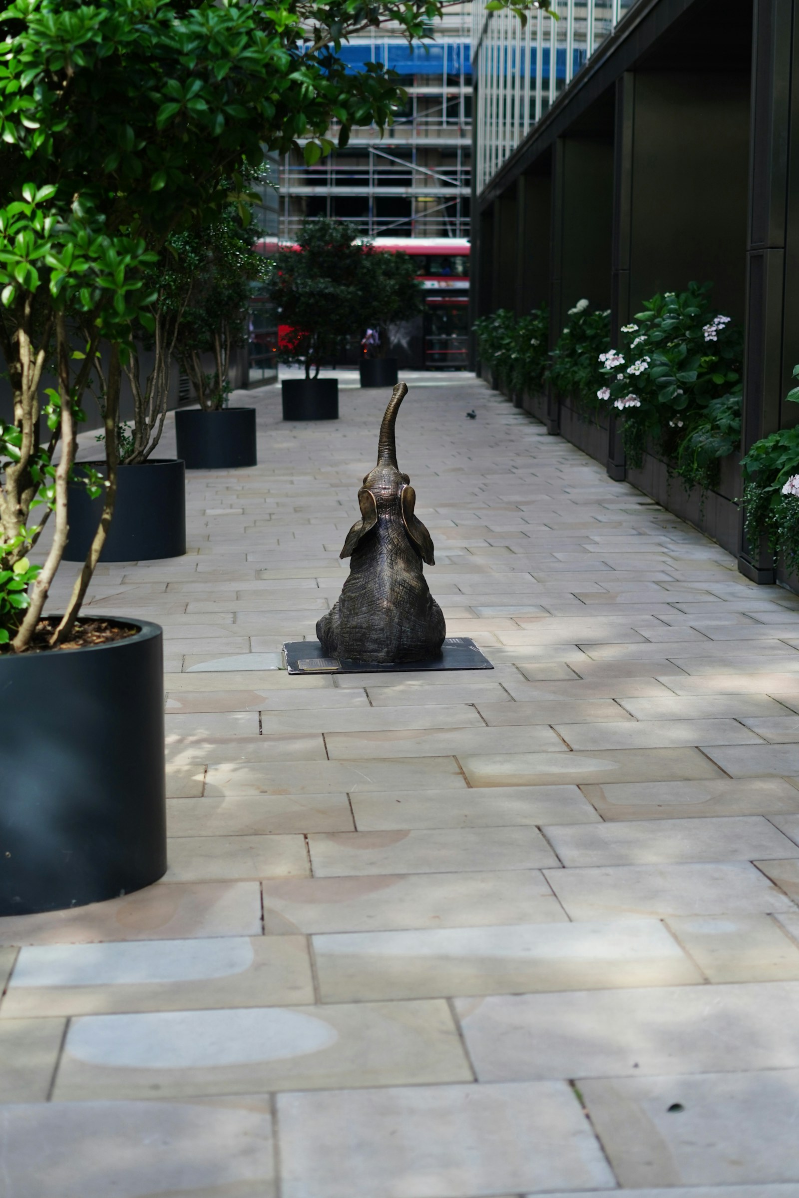 Dog statue beside a paved garden walkway