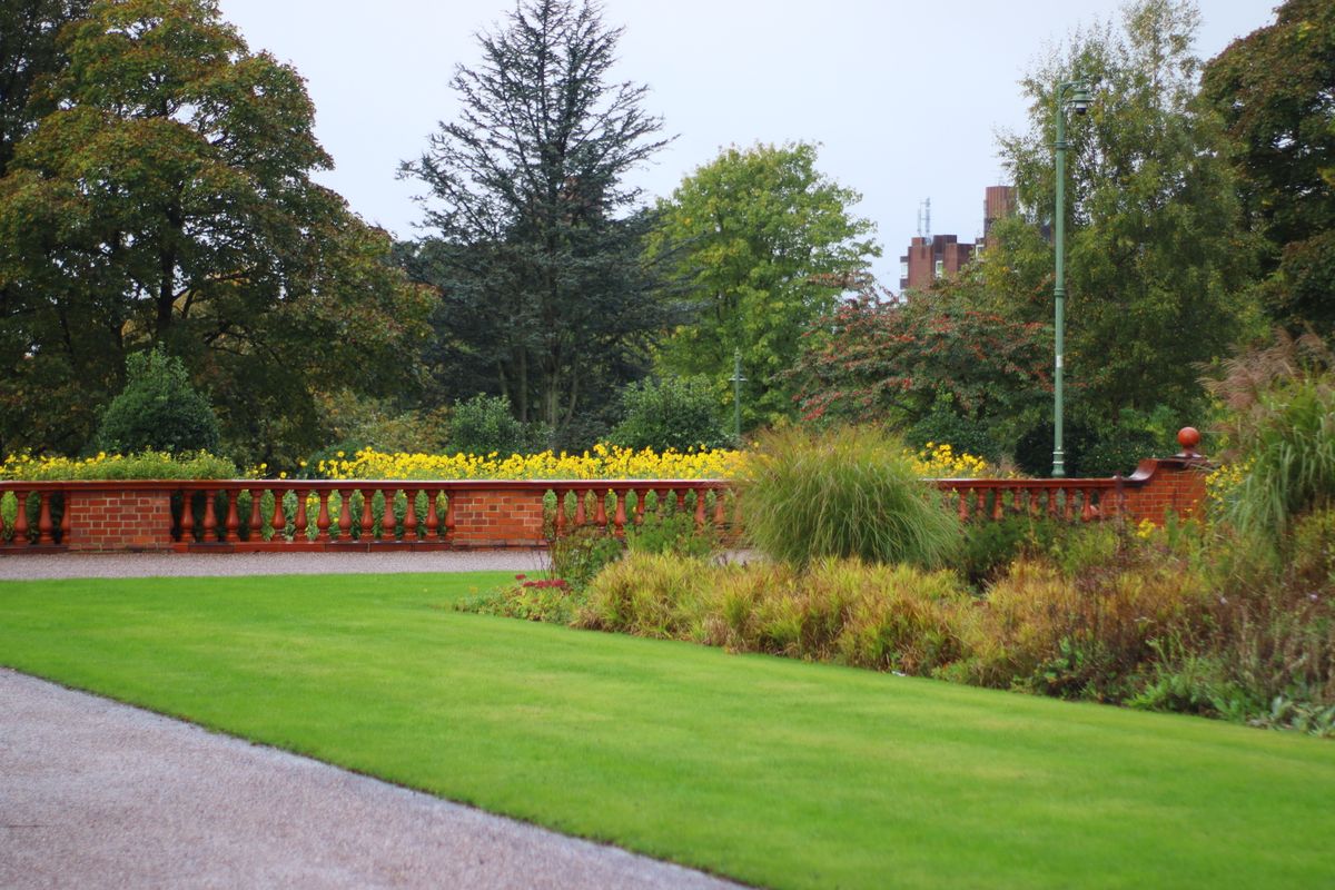 Well-kept lawn and planted borders in an English garden